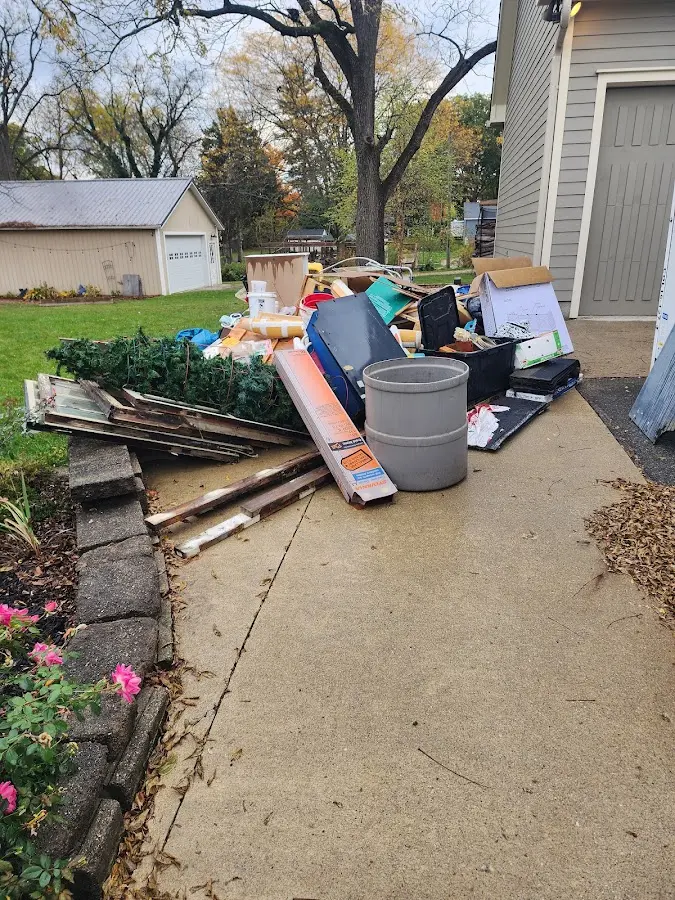 Dumpster being loaded with debris for Estate Cleanout Dumpster Rental in Fulton
